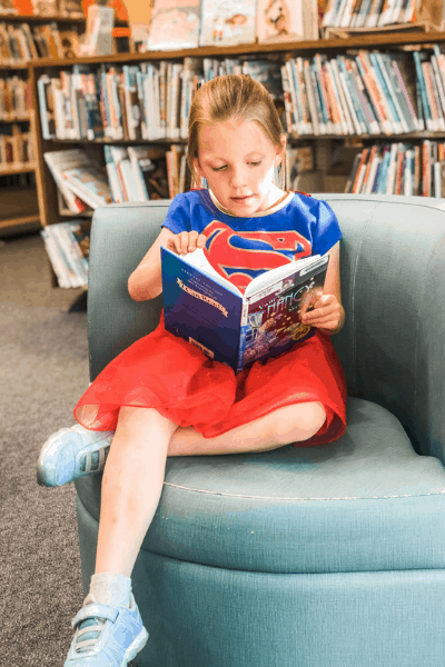 girl reading library book